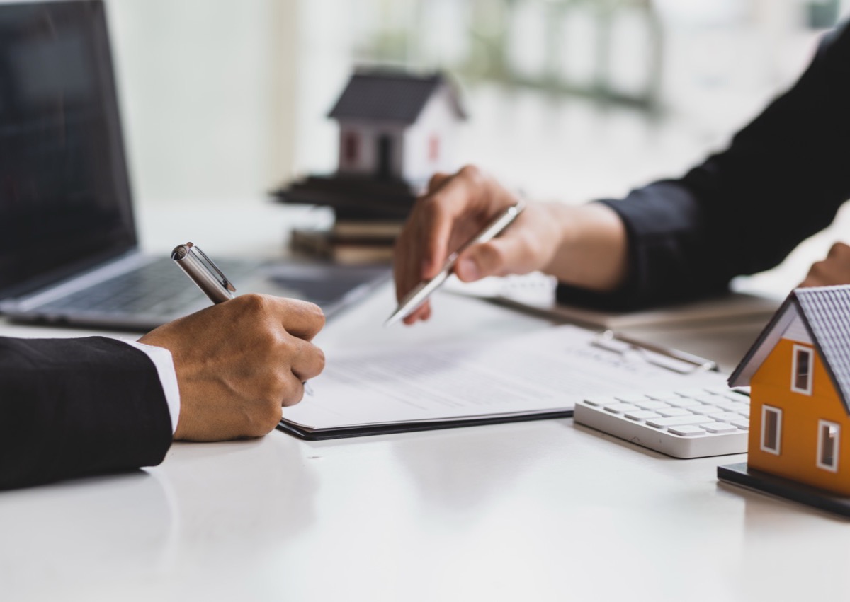Signing property documents at a desk